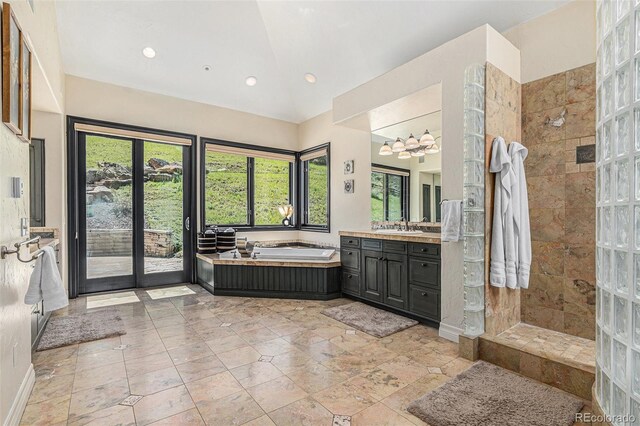 12963 Silver Elk Ln, Littleton, CO 80127 - full bathroom featuring lofted ceiling, a garden tub, recessed lighting, walk in shower, and a chandelier