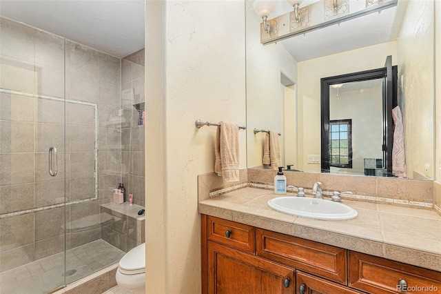 12963 Silver Elk Ln, Littleton, CO 80127 - bathroom with toilet, a stall shower, and vanity