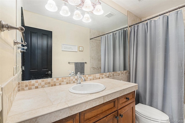12963 Silver Elk Ln, Littleton, CO 80127 - bathroom with toilet, decorative backsplash, vanity, and a shower with shower curtain