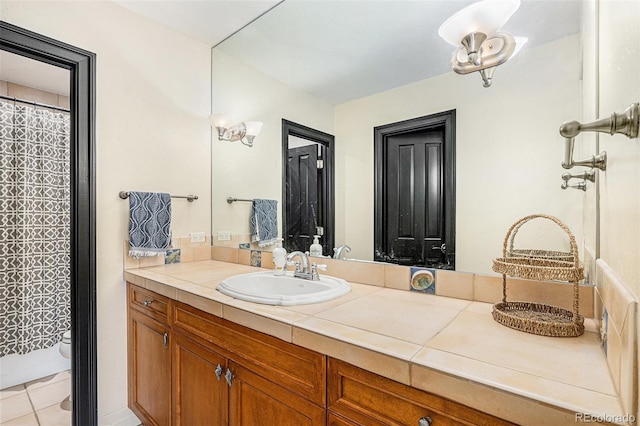12963 Silver Elk Ln, Littleton, CO 80127 - bathroom featuring vanity, toilet, tile patterned floors, and a shower with shower curtain