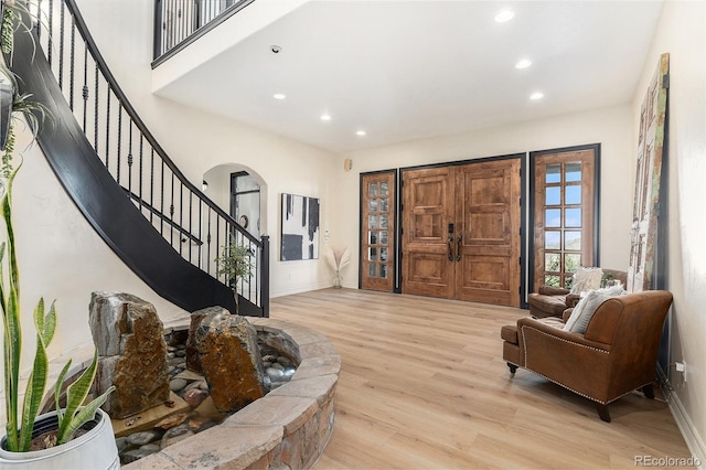 12963 Silver Elk Ln, Littleton, CO 80127 - entrance foyer featuring recessed lighting, light wood-type flooring, stairs, baseboards, and arched walkways