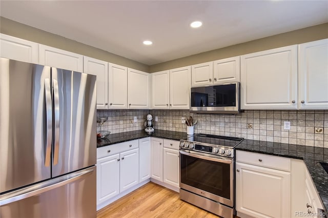 kitchen with stainless steel appliances, recessed lighting, white cabinetry, and light wood-style flooring