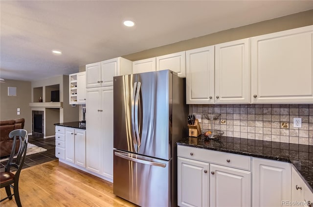 kitchen featuring recessed lighting, freestanding refrigerator, white cabinets, and tasteful backsplash