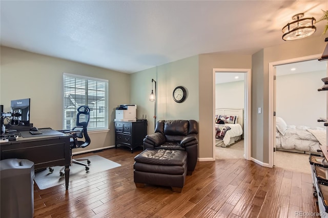 office space with baseboards and wood finished floors