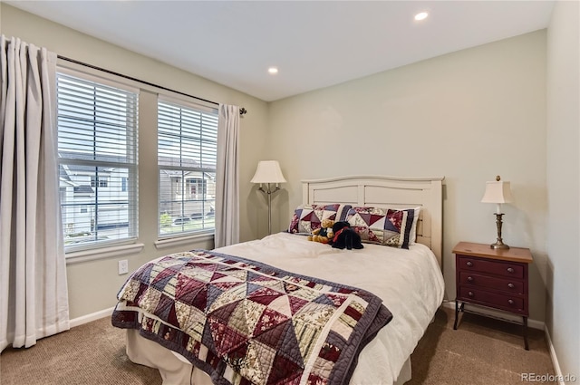 carpeted bedroom with recessed lighting, baseboards, and multiple windows