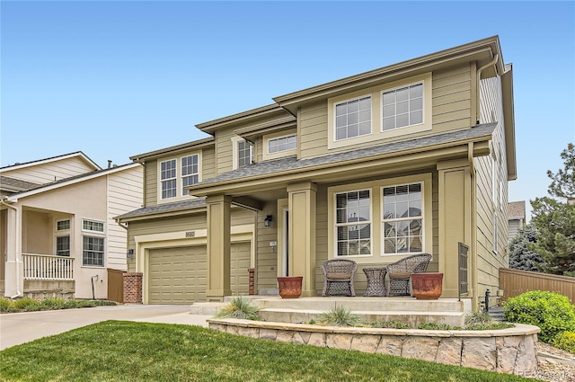 view of front of house with a porch, an attached garage, fence, and driveway