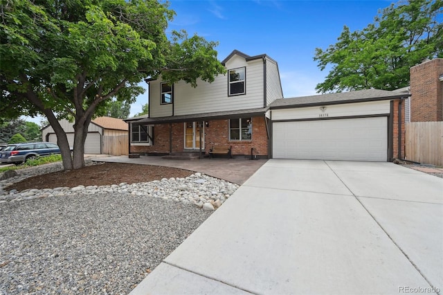 10378 W Weaver Ave, Littleton, CO 80127 - traditional-style home with brick siding, an attached garage, and concrete driveway