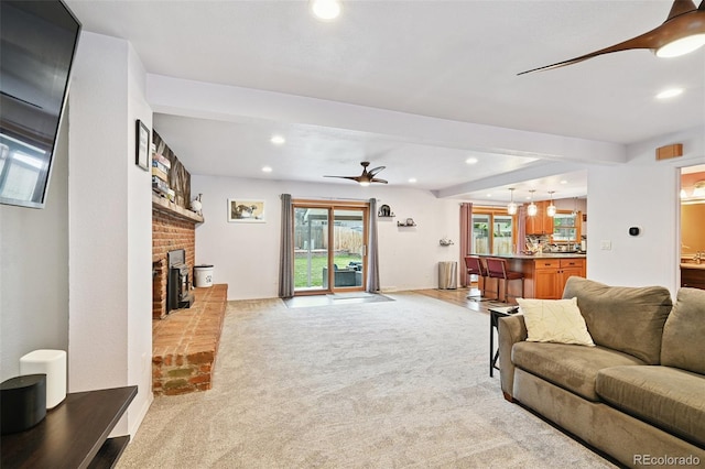 10378 W Weaver Ave, Littleton, CO 80127 - living area with a ceiling fan, recessed lighting, light colored carpet, a fireplace, and healthy amount of natural light