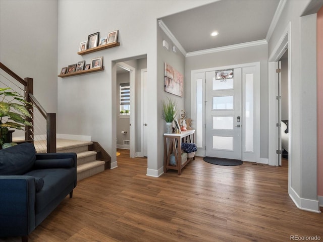 foyer entrance with crown molding and dark wood-type flooring