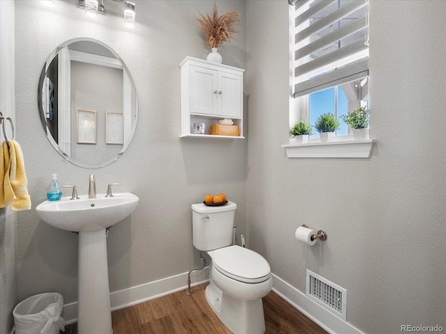 bathroom with sink, hardwood / wood-style flooring, and toilet