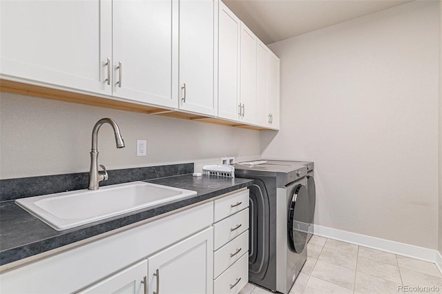 clothes washing area featuring washer hookup, sink, light tile patterned floors, and cabinets