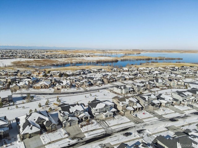 snowy aerial view featuring a water view