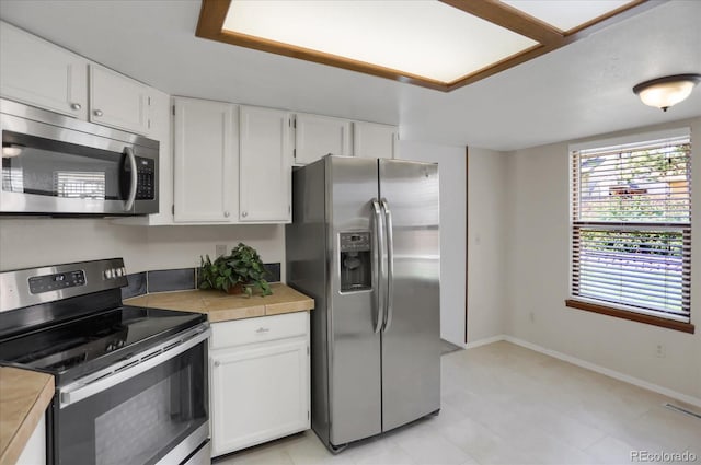 12089 W Burgundy Ave, Littleton, CO 80127 - kitchen with appliances with stainless steel finishes and white cabinetry