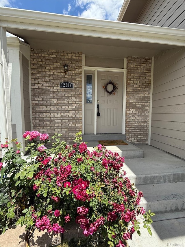 12089 W Burgundy Ave, Littleton, CO 80127 - property entrance with brick siding and a porch