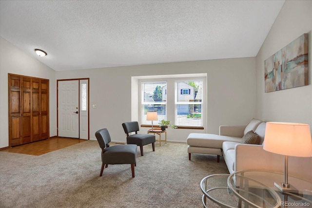 12089 W Burgundy Ave, Littleton, CO 80127 - living room featuring vaulted ceiling, carpet floors, and a textured ceiling