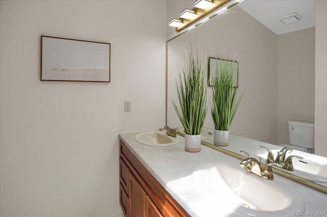 12089 W Burgundy Ave, Littleton, CO 80127 - bathroom featuring double vanity and toilet