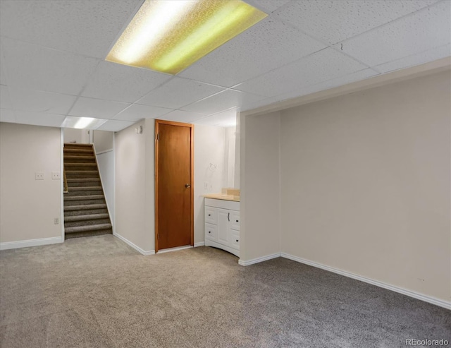 12089 W Burgundy Ave, Littleton, CO 80127 - finished below grade area featuring a drop ceiling, carpet, and stairs