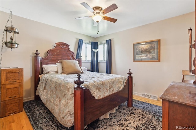 bedroom with light wood finished floors, baseboards, and visible vents