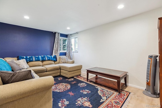 living area featuring light wood-style floors, baseboards, and recessed lighting