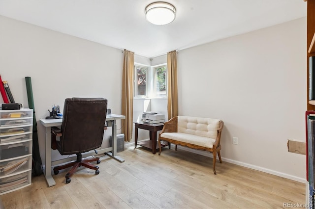 office area with light wood-style flooring and baseboards
