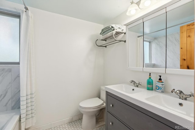 bathroom featuring toilet, a healthy amount of sunlight, and a sink
