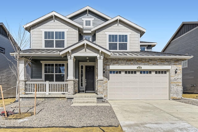 craftsman inspired home with covered porch, a standing seam roof, driveway, and stone siding