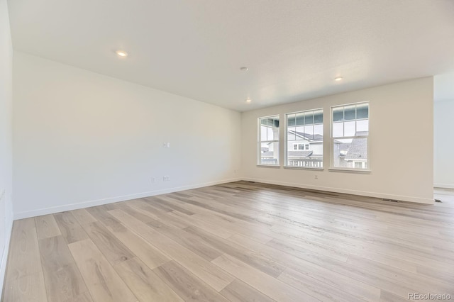 unfurnished room featuring light wood-style floors, baseboards, and recessed lighting