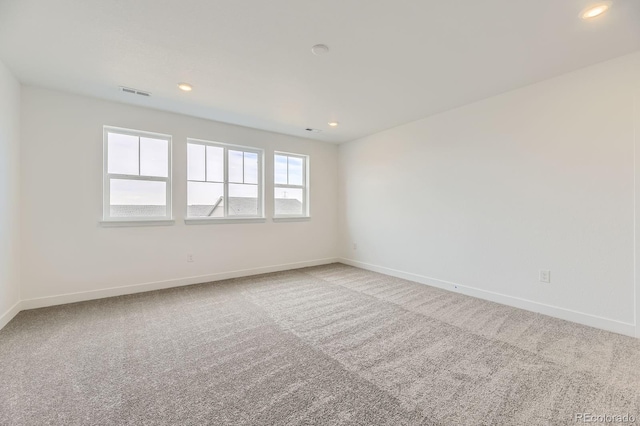 spare room with baseboards, carpet flooring, visible vents, and recessed lighting