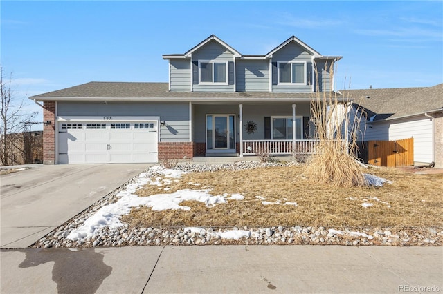 view of property featuring a garage and covered porch