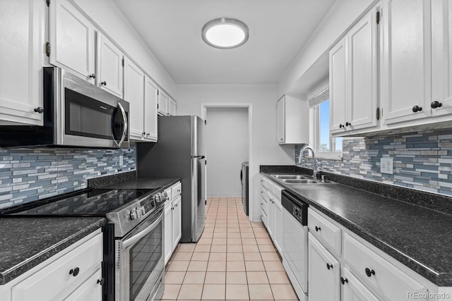 kitchen featuring light tile patterned flooring, stainless steel appliances, white cabinetry, and sink