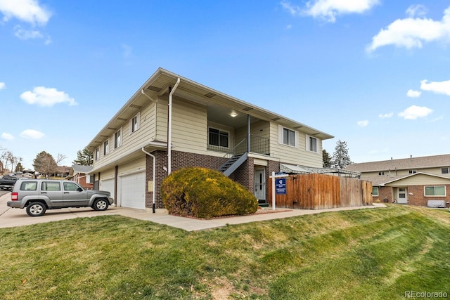 view of front facade with a garage and a front lawn