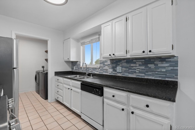 kitchen with dishwasher, white cabinets, sink, decorative backsplash, and washing machine and dryer