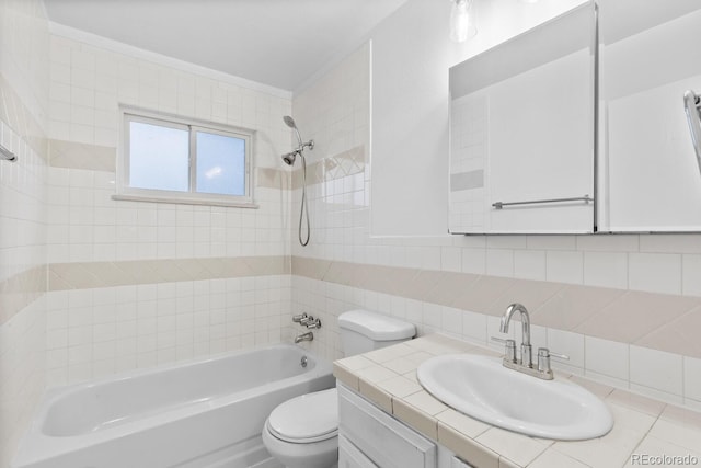 full bathroom with decorative backsplash, toilet, tiled shower / bath, and vanity