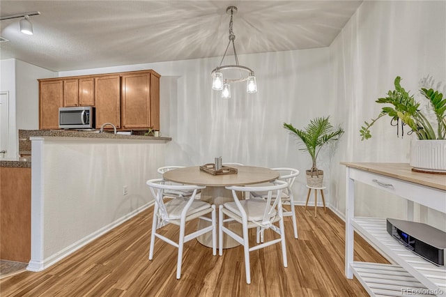 7140 Simms St Unit 102, Arvada, CO 80004 - dining space featuring light wood-style floors and baseboards