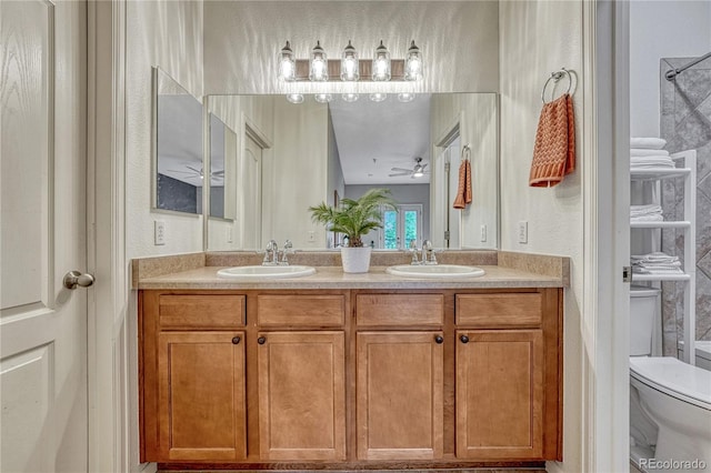 7140 Simms St Unit 102, Arvada, CO 80004 - bathroom with double vanity, toilet, a ceiling fan, and a textured wall