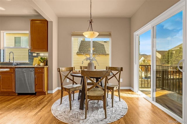 dining room with light wood-style flooring and baseboards