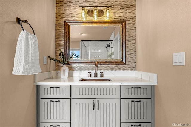 bathroom featuring vanity, backsplash, and walk in shower