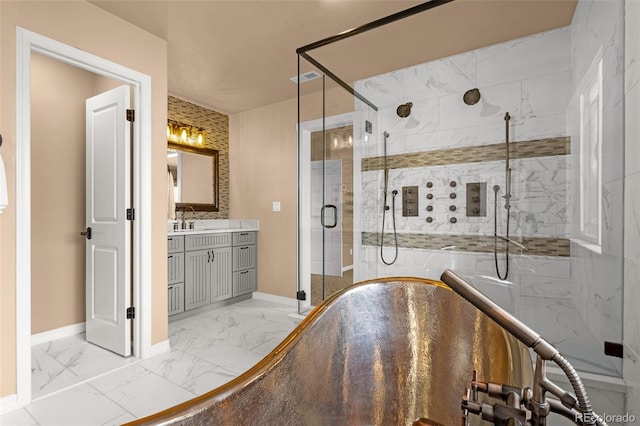 bathroom with baseboards, marble finish floor, and a shower stall