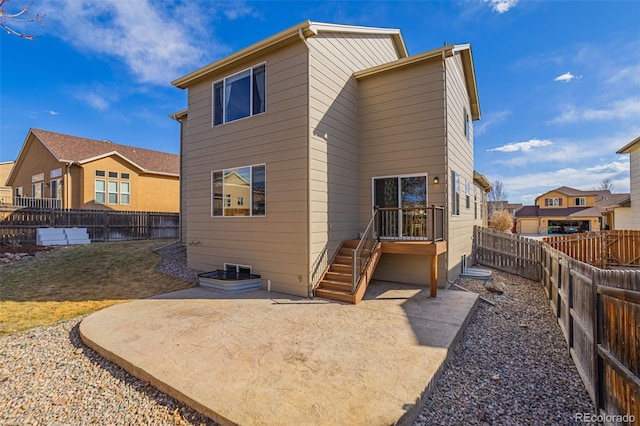 back of house featuring a patio, a fenced backyard, and a residential view