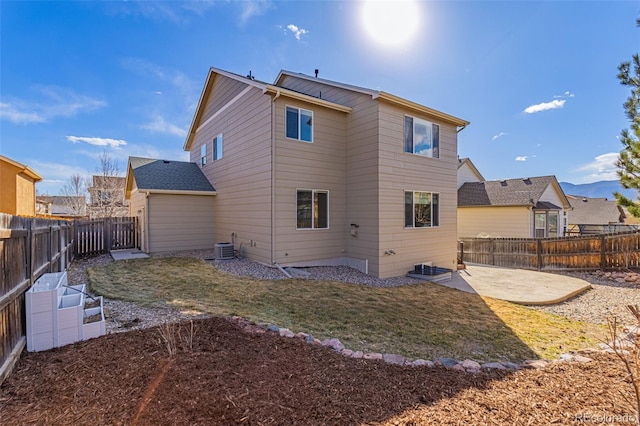 back of house with a patio, central air condition unit, a yard, and a fenced backyard