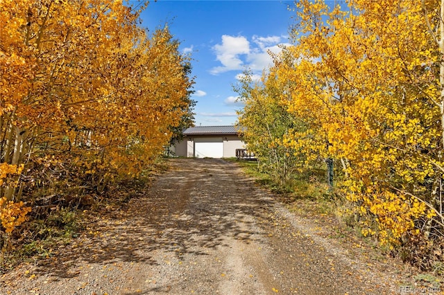 view of front of home with a garage and an outdoor structure