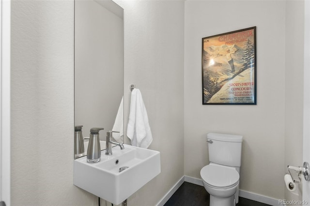 5101 Quitman St, Denver, CO 80212 - bathroom with toilet, baseboards, a sink, and wood finished floors
