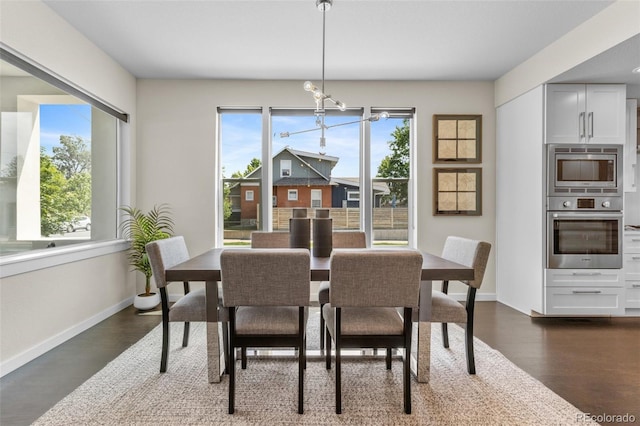 5101 Quitman St, Denver, CO 80212 - dining area featuring baseboards, dark wood-type flooring, and a chandelier