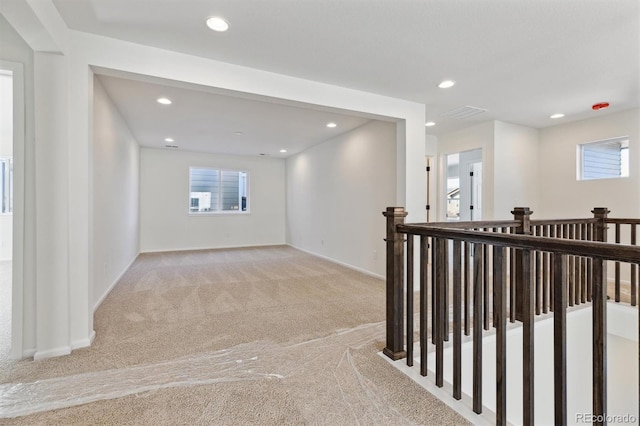 hallway with light carpet