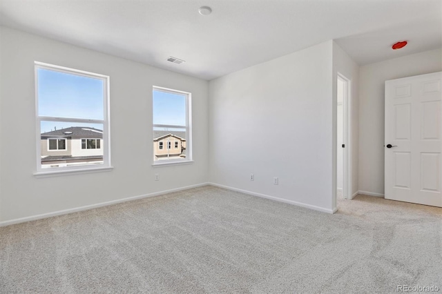 unfurnished room with light colored carpet