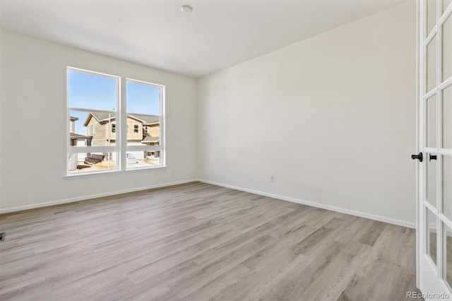 spare room featuring light wood-type flooring