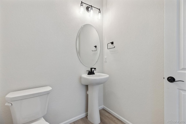 bathroom featuring sink, hardwood / wood-style floors, and toilet