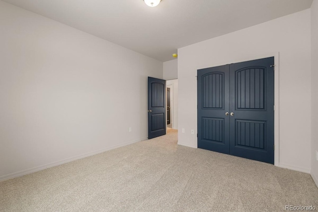 unfurnished bedroom featuring carpet flooring and a closet