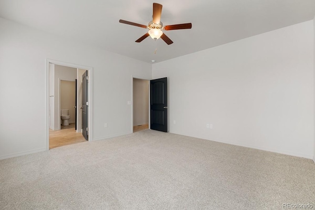 unfurnished bedroom with connected bathroom, light colored carpet, and ceiling fan