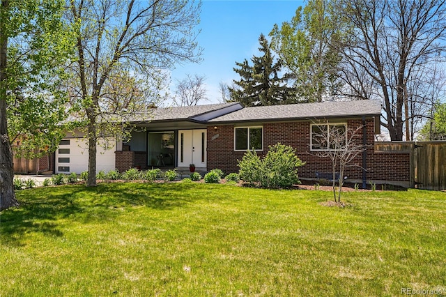 ranch-style home with an attached garage, brick siding, and a shingled roof